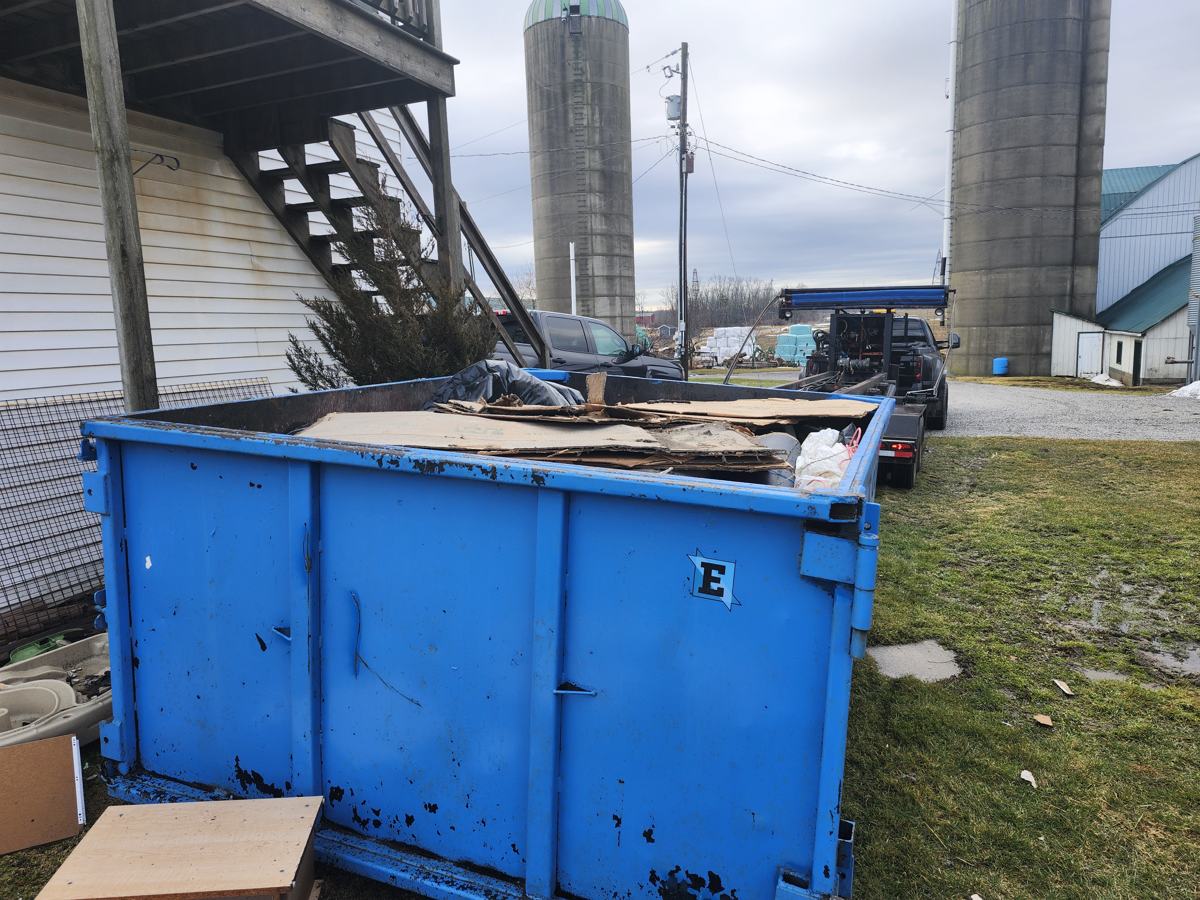 Eastco Hauling roll-off bin at a rural property