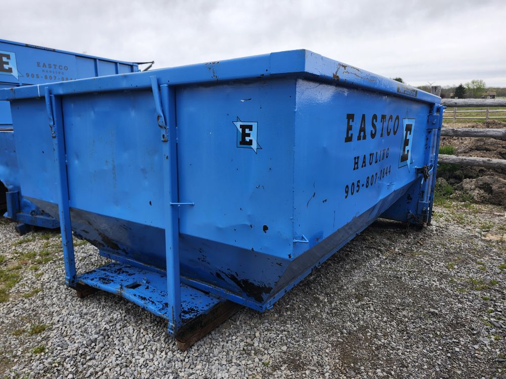 Eastco Hauling branded roll-off bin with phone number